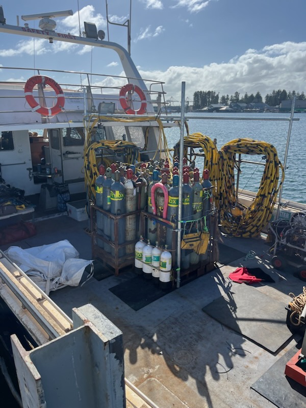 Gas cylinder rack and hose reels secured on deck