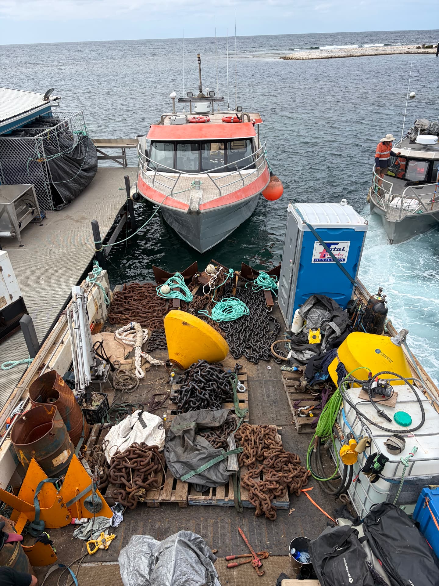 Mooring chain and buoys loaded on the barge deck